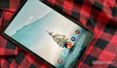 An Android tablet running Smart Launcher 6 on a red and black flannel shirt.