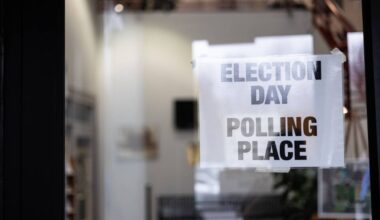 a glass door with a sign taped to it, reading 'election day - polling place'