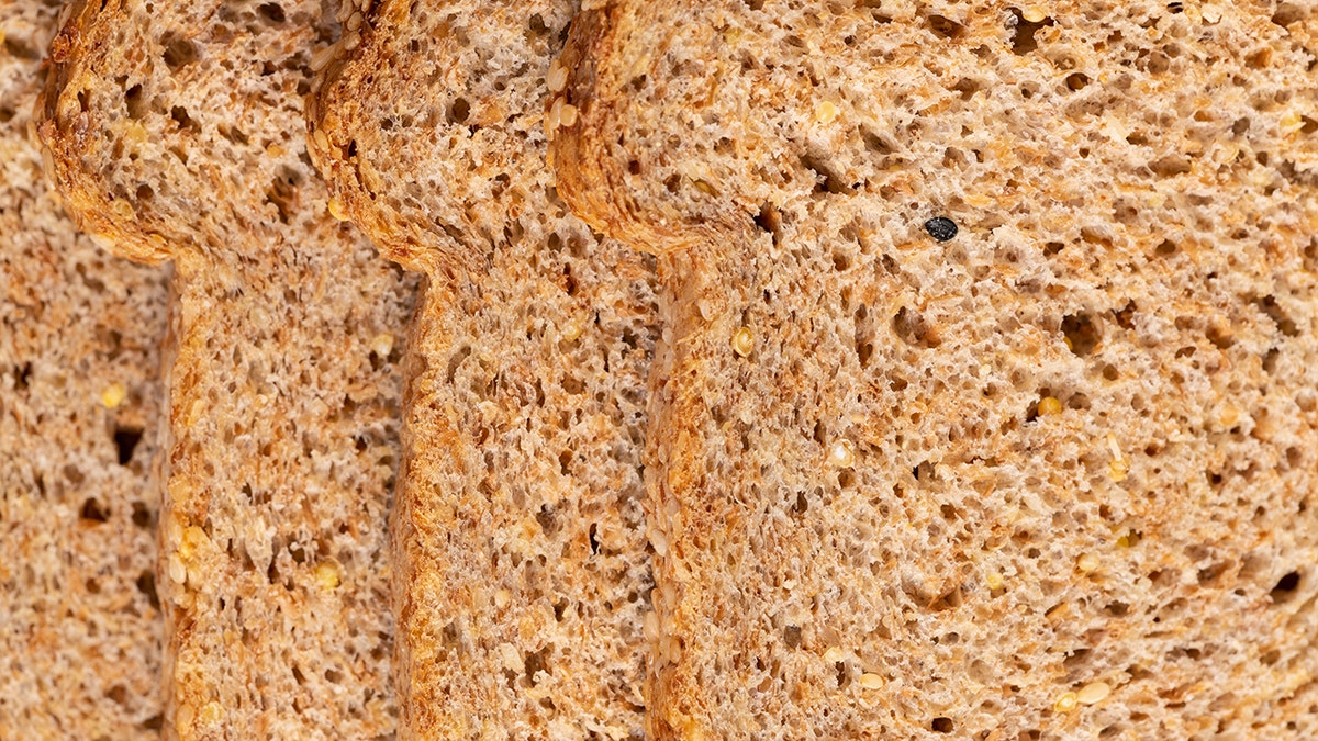 A close-up view of three loaves of sprouted grain bread.