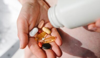 Closeup photo of supplements with a white bottle. Woman take omega 3, multivitamins, vitamins B, C, D, collagen tablets, probiotics, iron capsule. Girl hold vitamins daily. Top view.