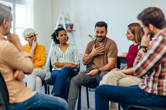 People of various ages, genders and ethnicities gathered in discussion.