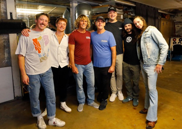 Members of Sea Poodle gather before their concert for the surf film "Confluence" on Dec. 8 in Encinitas. From left are Hunter Bragg, John Hooper, Bailey Cecil, Mikko Fleming, Matt Donoghue, Cliff Brinser and Jake Luther. (K.C. Alfred / The San Diego Union-Tribune)