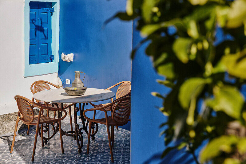 vibrant blue facade brings new life to the monk retreat on leros island, greece