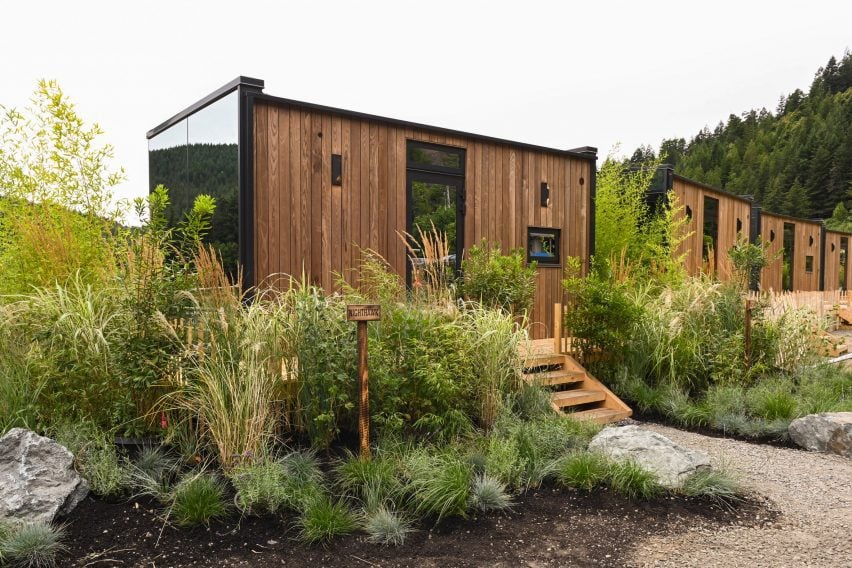 Row of cabins surrounded by planting