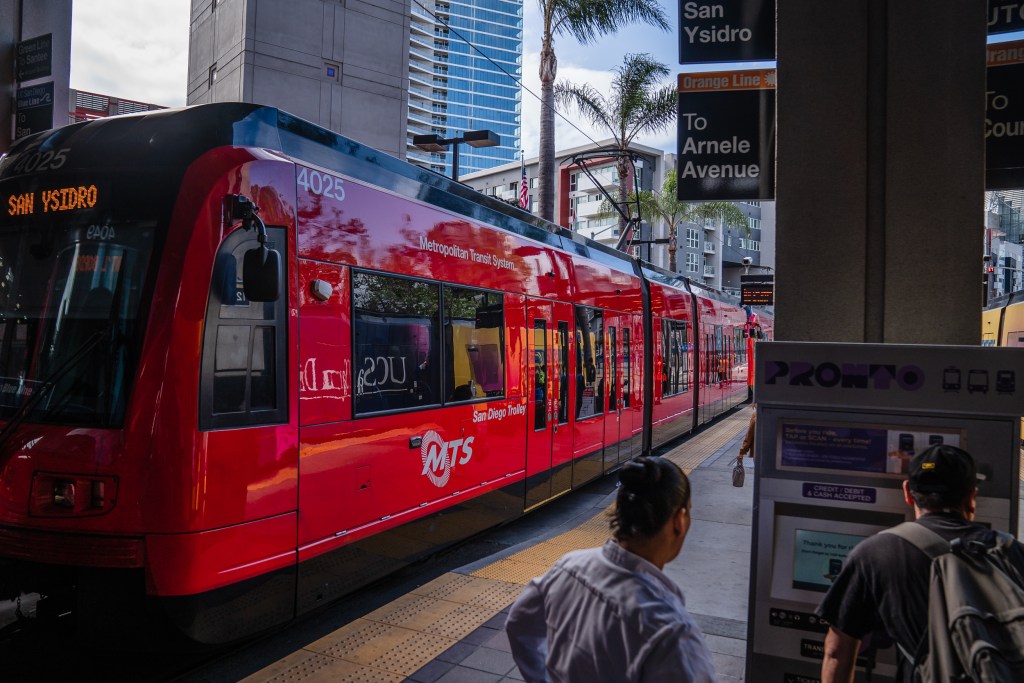 A man uses the PRONTO machine to purchase a ticket to ride the trolley at 12th and Imperial Avenue in downtown on May 1, 2023.