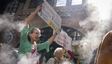 Activists march down Park Avenue to Trump Tower in New York for climate justice