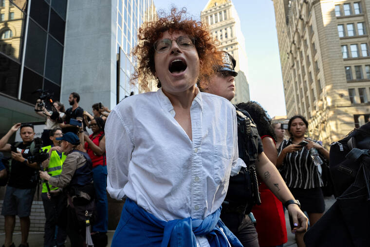 REUTERS/DAVID DEE DELGADO
                                New York City Police Department (NYPD) officers detain a person during a protest against Immigration and Customs Enforcement (ICE) outside U.S. immigration court in Manhattan, New York City.