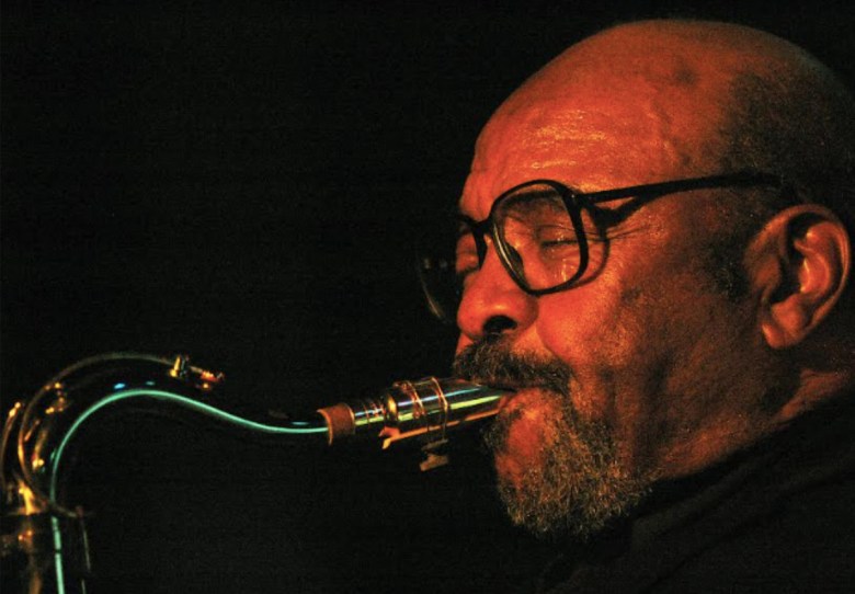 The jazz saxophonist James Moody performing, with instrument raised to his mouth.