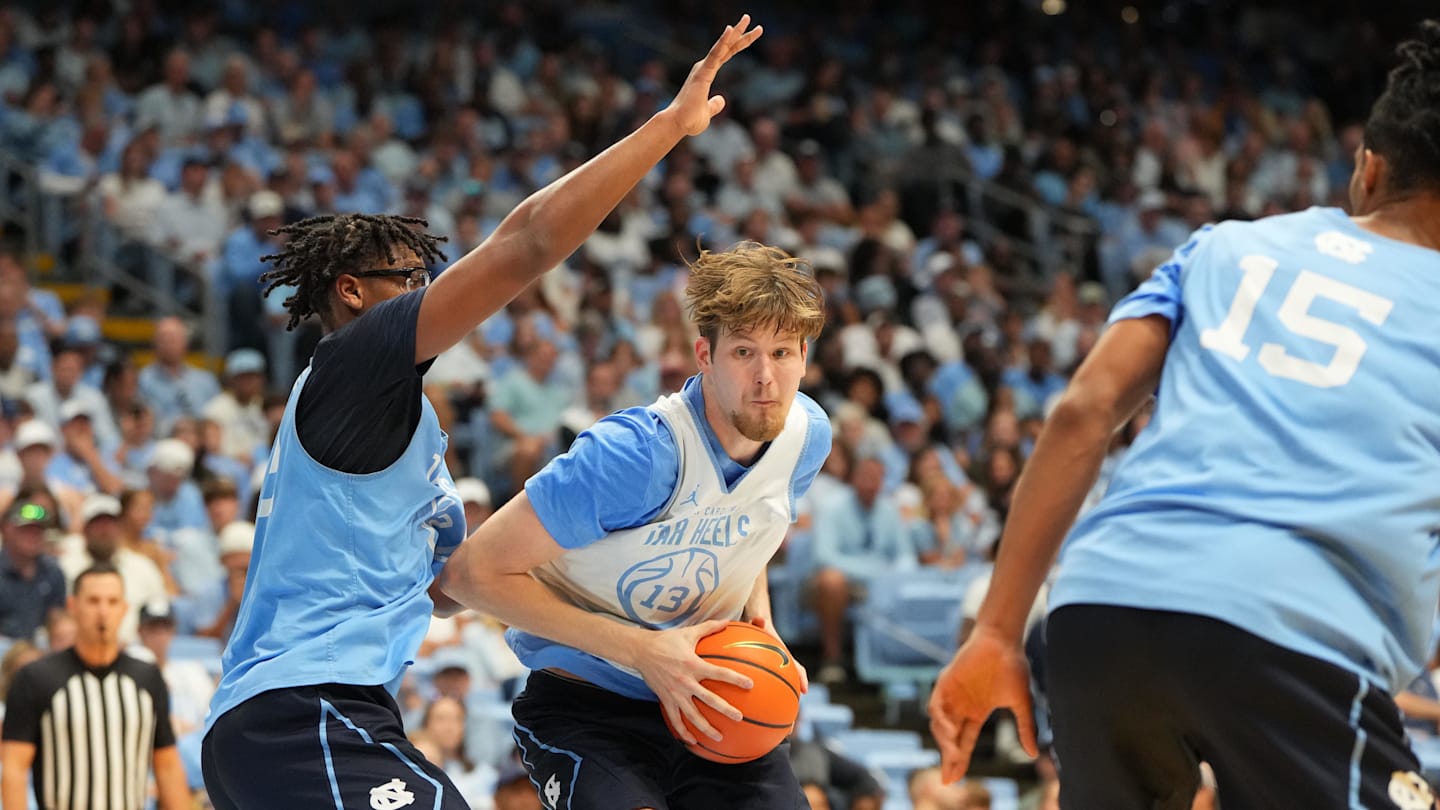 Oct 4, 2025; Charlotte, NC, USA; North Carolina Tar Heels center Henri Veesaar (13) with the ball as forward James Brown (2) defends in the first half at Dean E. Smith Center. Mandatory Credit: Bob Donnan-Imagn Images