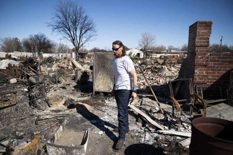 Scott McBroom walks through the rubble of his burned house in Fritch on March 1, 2024.
