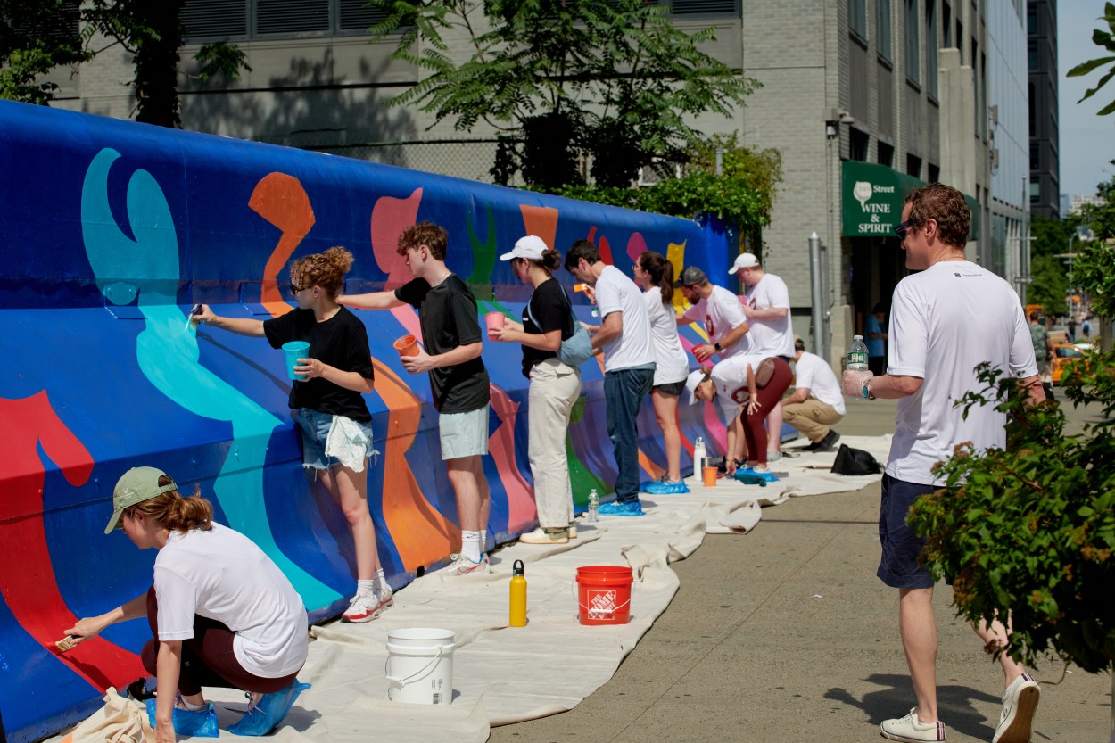 Volunteers working on mural along W34th Street