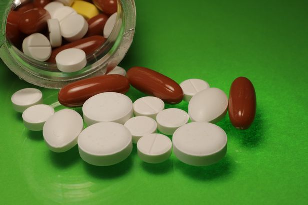 Pills coming out of a bottle