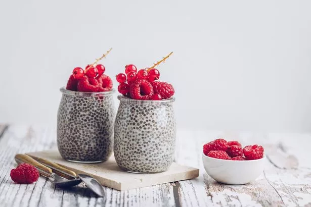Chia pudding jar with raspberry and currant fruits