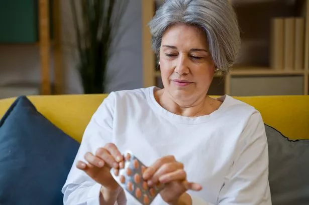 Woman taking tablets