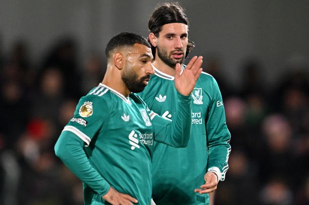 BRENTFORD, ENGLAND - OCTOBER 25: Dominik Szoboszlai of Liverpool speaks with teammate Mohamed Salah during the Premier League match between Brentford and Liverpool at Gtech Community Stadium on October 25, 2025 in Brentford, England. (Photo by Liverpool FC/Liverpool FC via Getty Images)