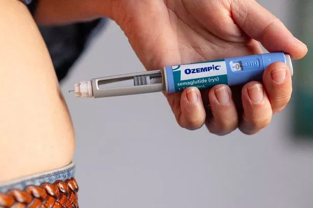 Person injecting Ozempic pen