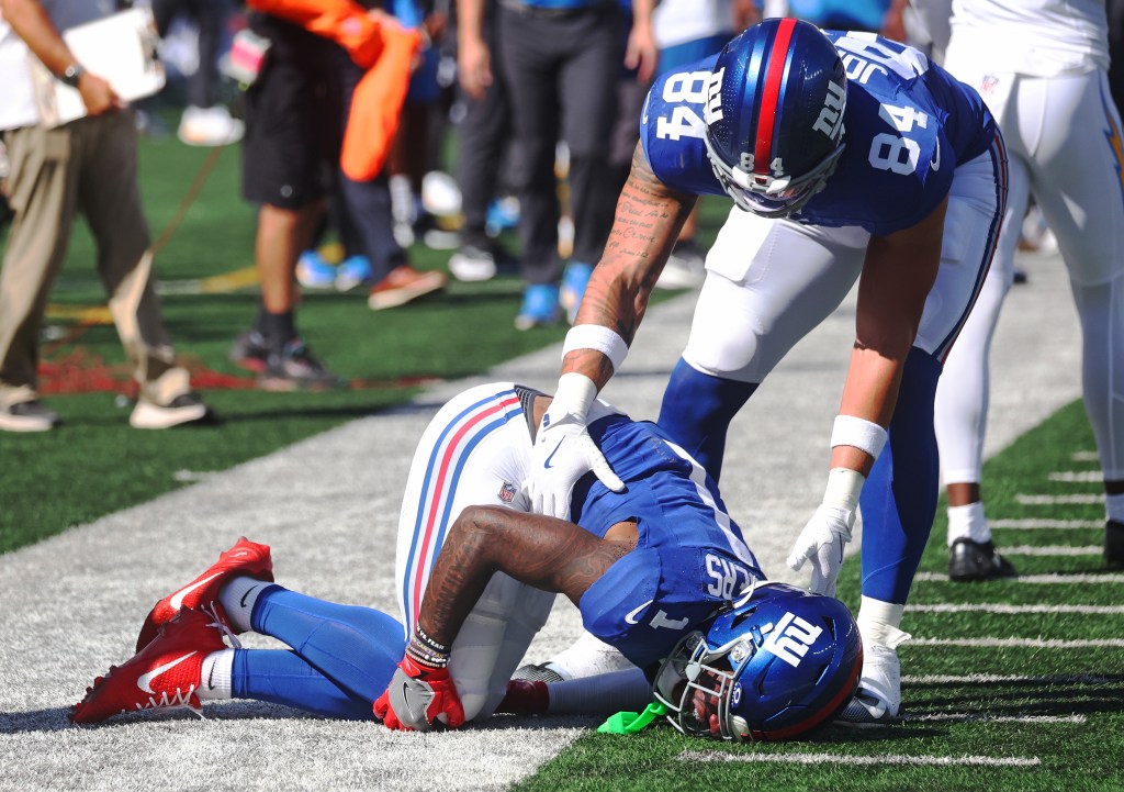 Wide receiver Malik Nabers #1 of the New York Giants jumps for a reception and falls behind cornerback Cam Hart #20 of the Los Angeles Chargers. Nabers is injured on the play during the first half when the New York Giants played the Los Angeles Chargers Sunday, September 28, 2025 at MetLife Stadium in East Rutherford, NJ.