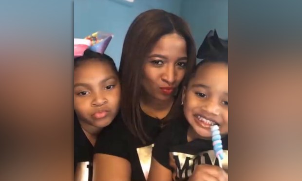 Correction Officer Shamika Mitchell is pictured with her two children prior to the Rikers attack.