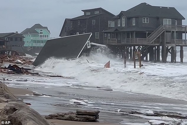 Waves from Hurricanes Humberto and Imelda destroy a home in Buxton, North Carolina, Tuesday, September 30, 2025