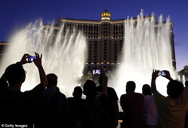 Las Vegas has been losing more than 300,000 visitors per month this year. Visitors watch the fountain show at the Bellagio