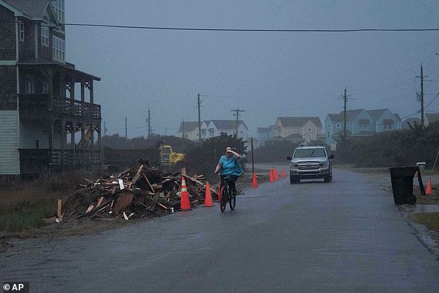 Coastal areas from South Carolina to New England are predicted to be hit with two to four inches of rainfall over the next few days. Pictured: Storms in Buxton, North Carolina on Sunday