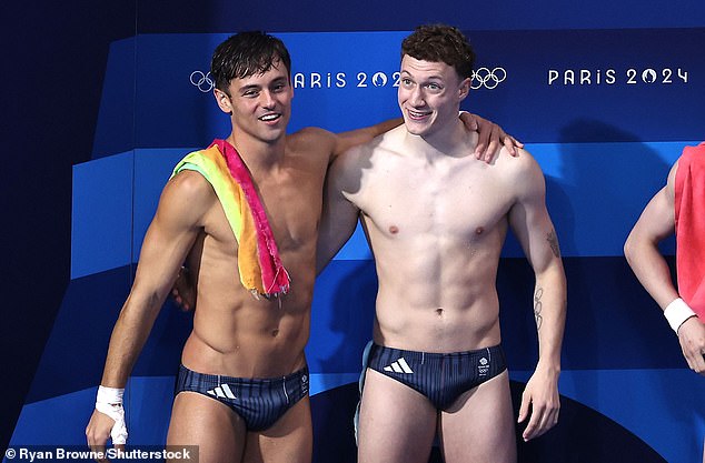 Six-pack-sporting athletes Tom Daley and Noah Williams of Great Britain celebrate winning the silver medal in the Men's Diving Synchronised 10m Platform Final Paris 2024 Olympic Games