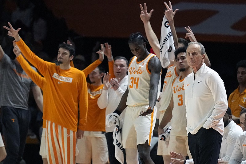 AP photo by Mark Humphrey / Tennessee men's basketball coach Rick Barnes, right, watches the action as his players celebrate a basket during an SEC regular-season game against Alabama on March 1 in Knoxville.