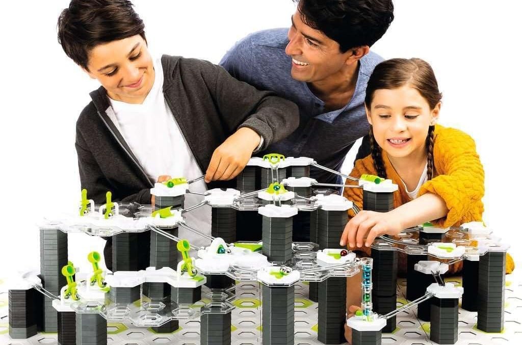 Man, woman, and child playing a board game.