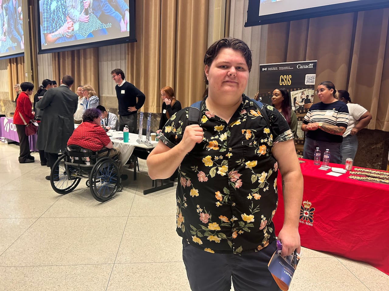 An attendee poses for a photo at a job fair.