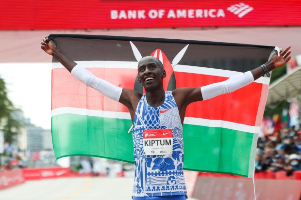 Kelvin Kiptum celebrates his Chicago Marathon world record victory, 2:00:35, in Chicago's Grant Park on Oct. 8, 2023. (Eileen T. Meslar/Chicago Tribune)