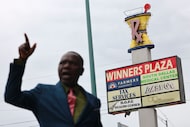 The sign of Winners Plaza is seen past Dallas Pastor Raphael Adebayo as he gives a tour of...