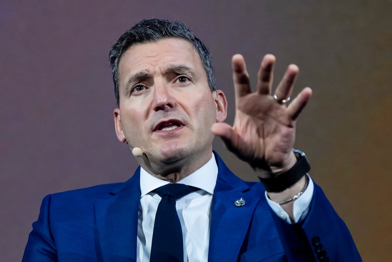 A man wearing a blue suit is shown.