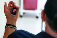 A pulse oximeter shows heart rate and blood oxygen levels during a physical therapy session...