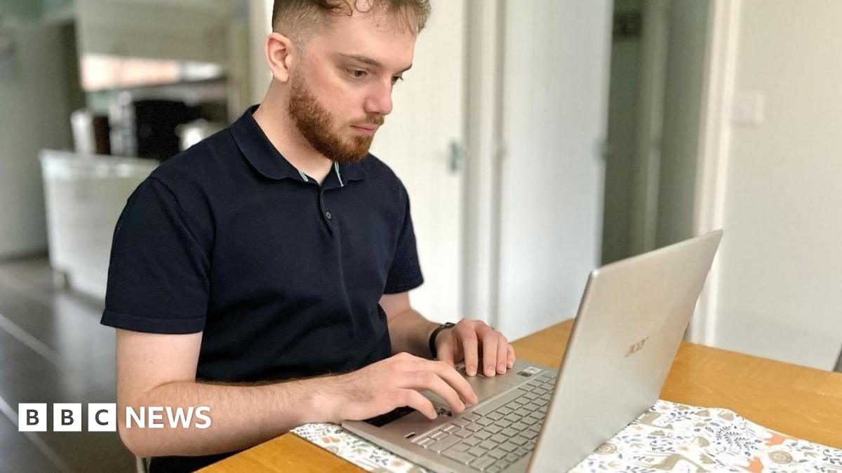 Joe Burgess on his lap top computer in his Felixstowe home looking for jobs