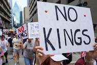 Demonstrators march along South Field Street in downtown Dallas during a 'No Kings' protest...