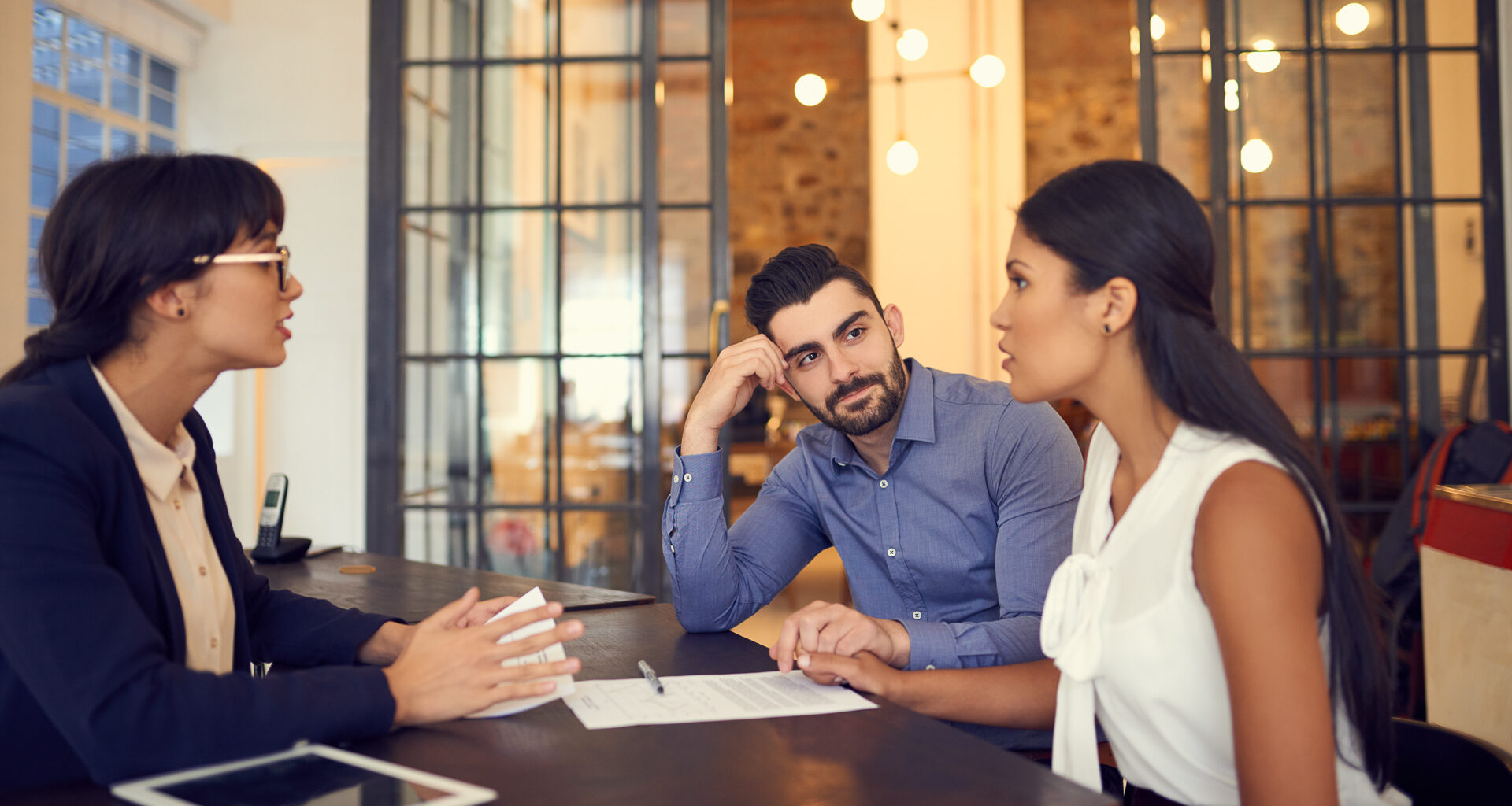 Shot of a young couple meeting with a financial planner in an office.