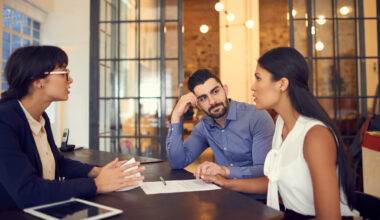 Shot of a young couple meeting with a financial planner in an office.
