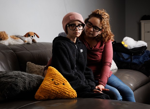 Ofelia Torres, 16, left, and her mother, Sandibell Hidalgo, 40, at their home on Oct. 20, 2025, in Chicago. Torres' father and Hidalgo's husband, Ruben Torres Maldonado, was taken by Immigration and Customs Enforcement officers over the weekend. Torres was diagnosed with rhabdomyosarcoma cancer in Dec. 2024. (Armando L. Sanchez/Chicago Tribune)
