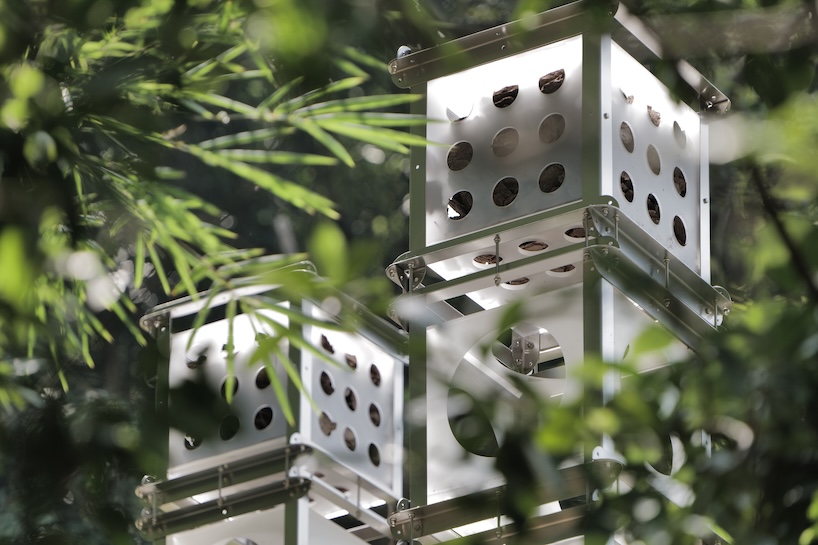 industrial modules and organic soil build architectural installation that grows with the forest