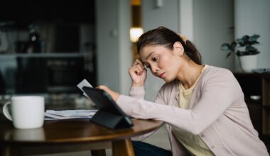 Asian Malay female planning family finances at home.