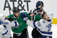 Dallas Stars defenseman Lian Bichsel (6) fights with Tampa Bay Lightning center Zemgus...