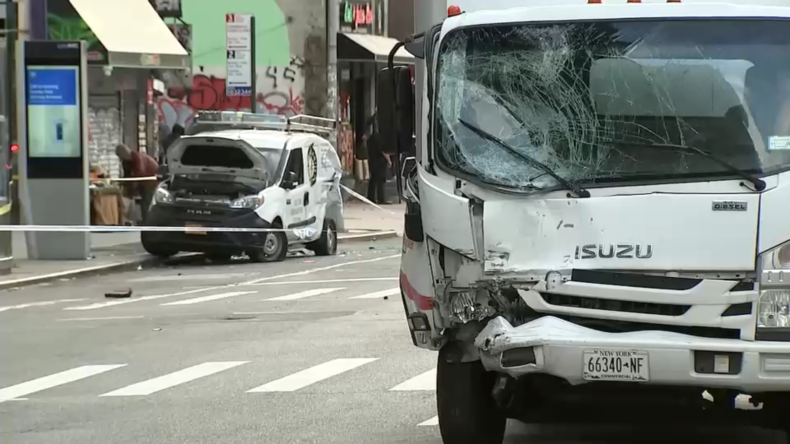 Midtown crash: 10 people injured after box truck strikes parked van, sending it onto sidewalk in Manhattan