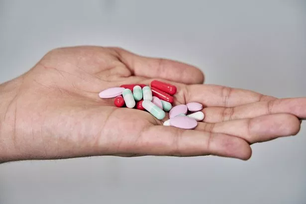 Person holding different medicines