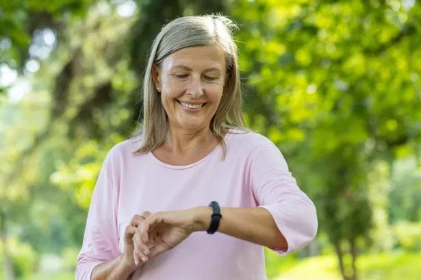Lady walking looking at watch 