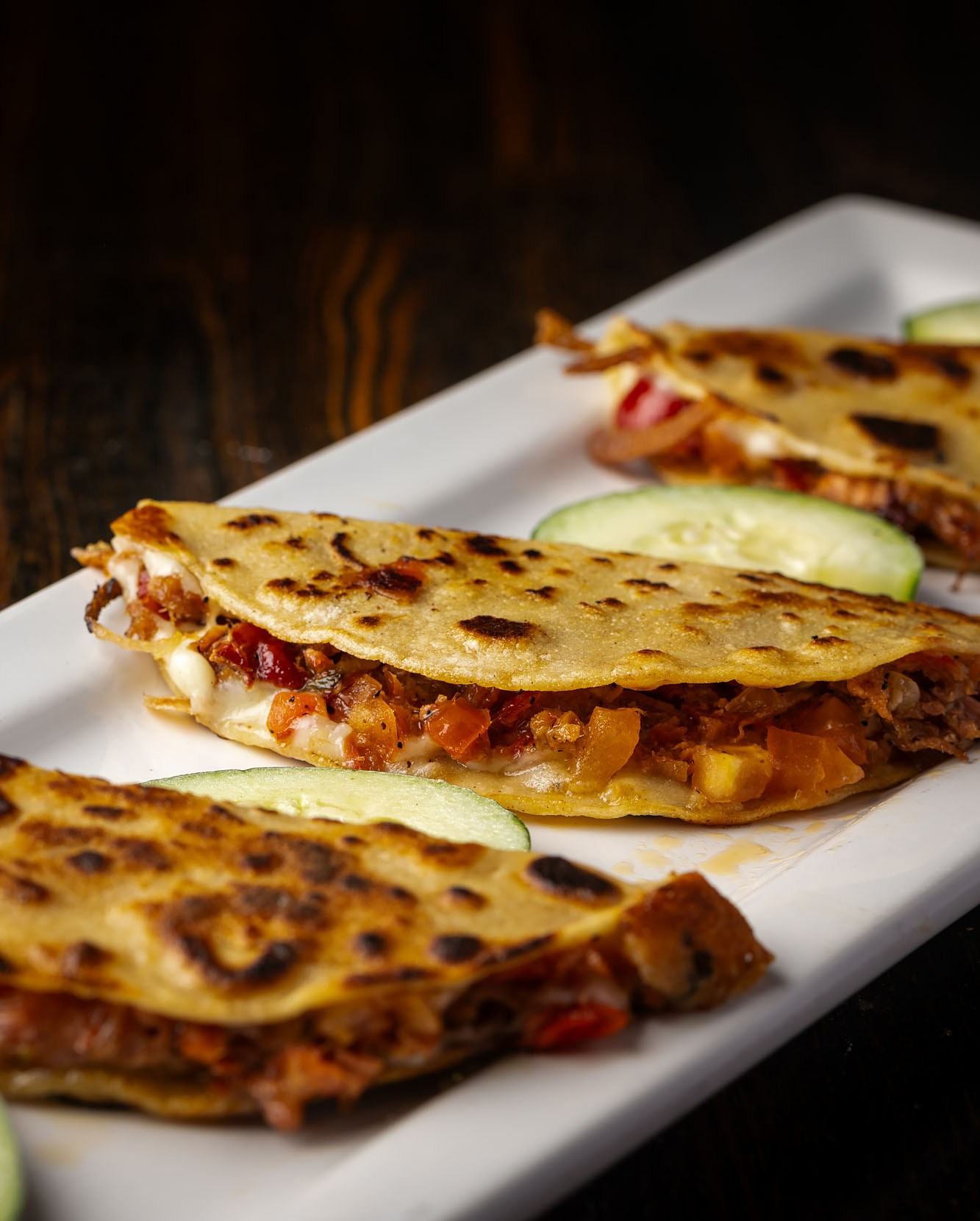 Marlin tacos with cheese on a plate.