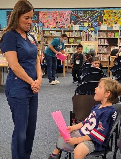 An Abrazo medical student helps prepare a Maryland School student during the school