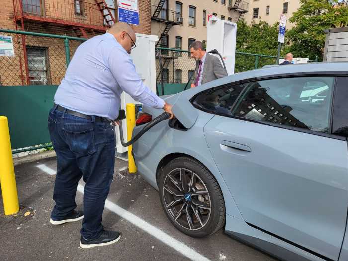 State Senator Gustavo Rivera plugged his personal electric vehicle, an all-electric BMW i4 dubbed "Ursula," into the newest fast charging EV kiosk in the East Bronx. Rivera said that he bought an electric vehicle because lawmakers in Albany have access to charging stations at the capitol, but that he still struggled to find convenient sources of energy within his own neighborhood.
