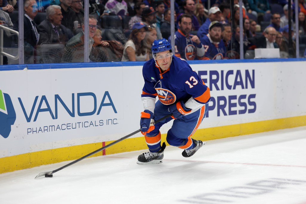 New York Islanders center Mathew Barzal (13) skates with the puck against the San Jose Sharks during the second period at UBS Arena. 