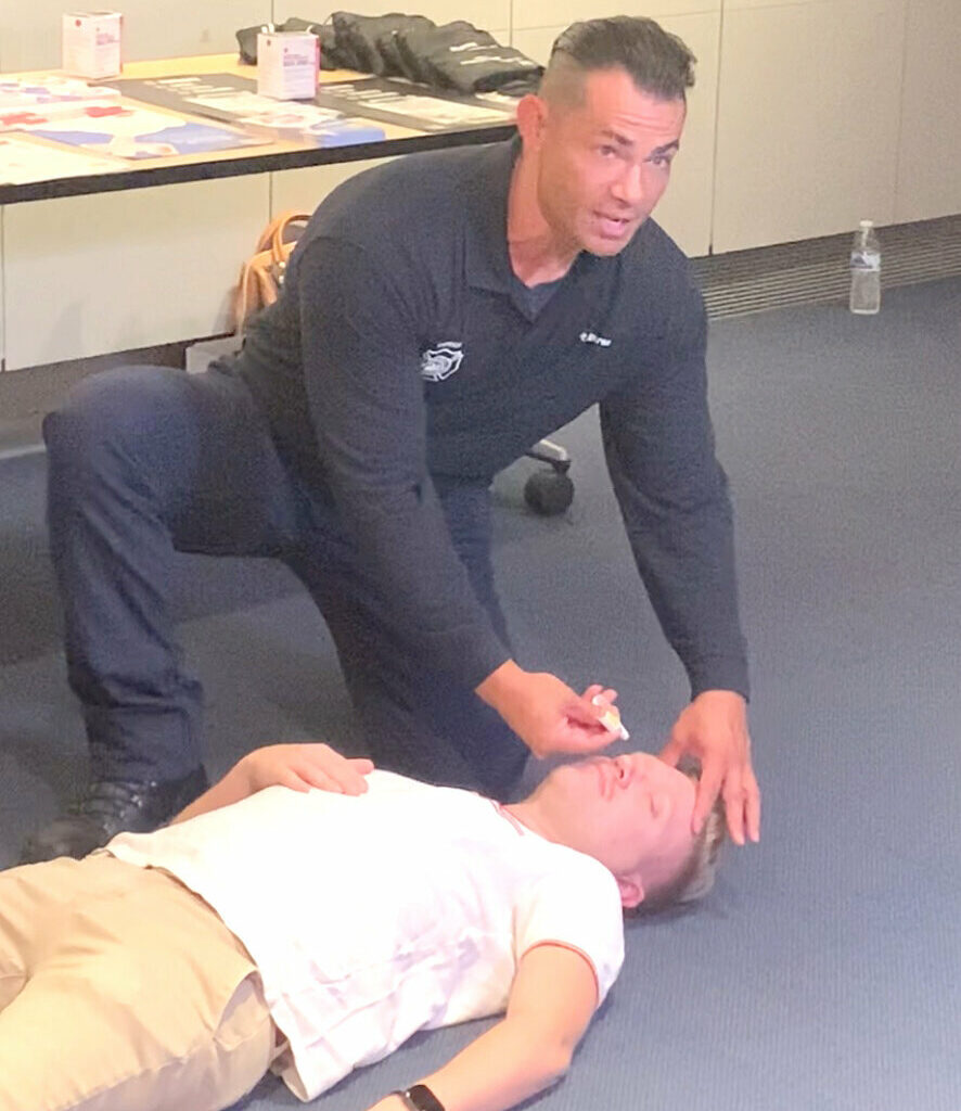 A Phoenix firefighter demonstrates how to administer the overdose-reversal nasal spray naloxone during a media event at Phoenix’s Burton Barr Central Library when the city’s naloxone distribution program launched in August 2023.
