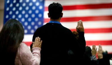 FILE - In this Feb. 15, 2017 file photo, people take the oath of citizenship during a naturalization ceremony at the Los Angeles Convention Center. A new citizenship test is rolling out this year, and Valley groups are helping applicants prepare.
